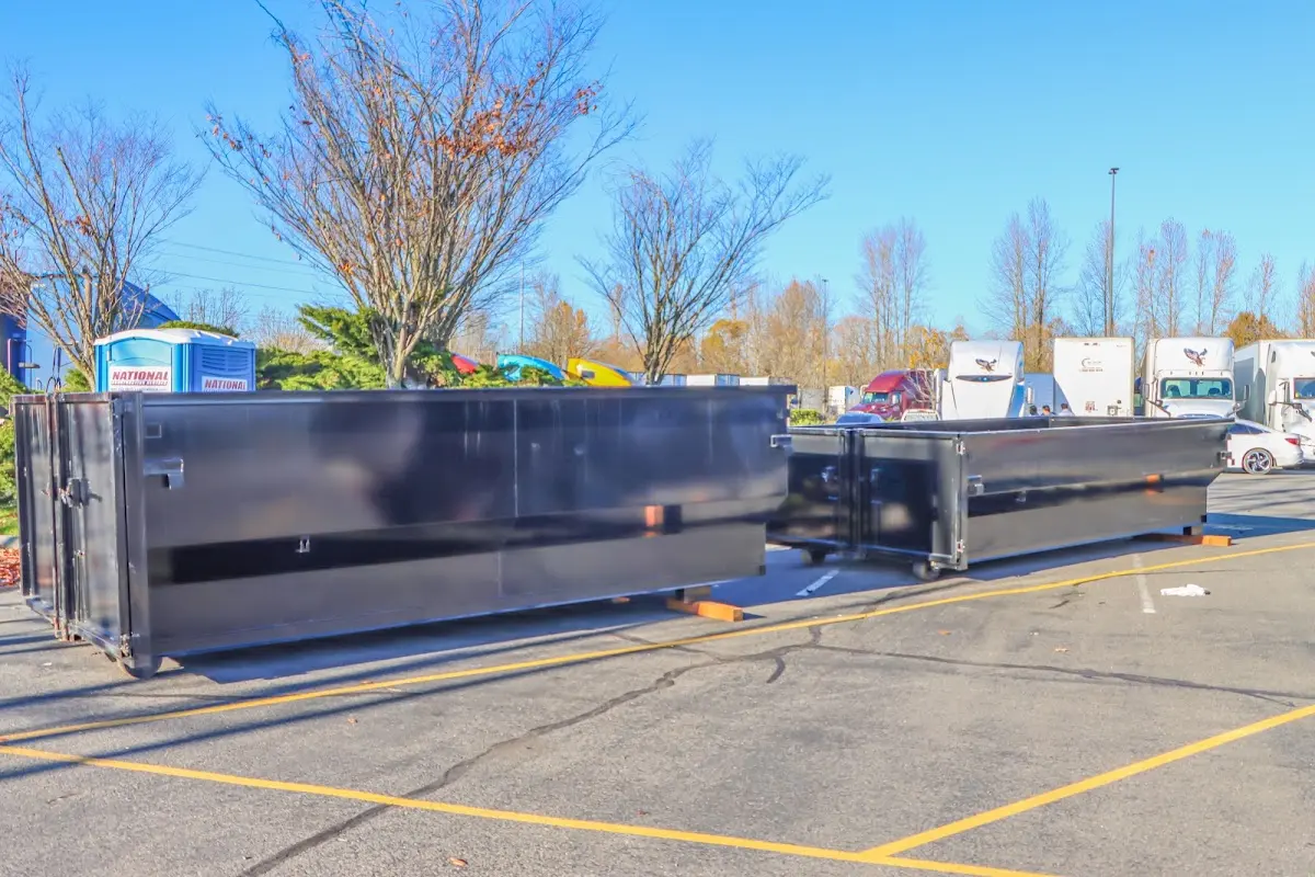Professional dumpster rental service with roll-off container on residential driveway in South St. Paul